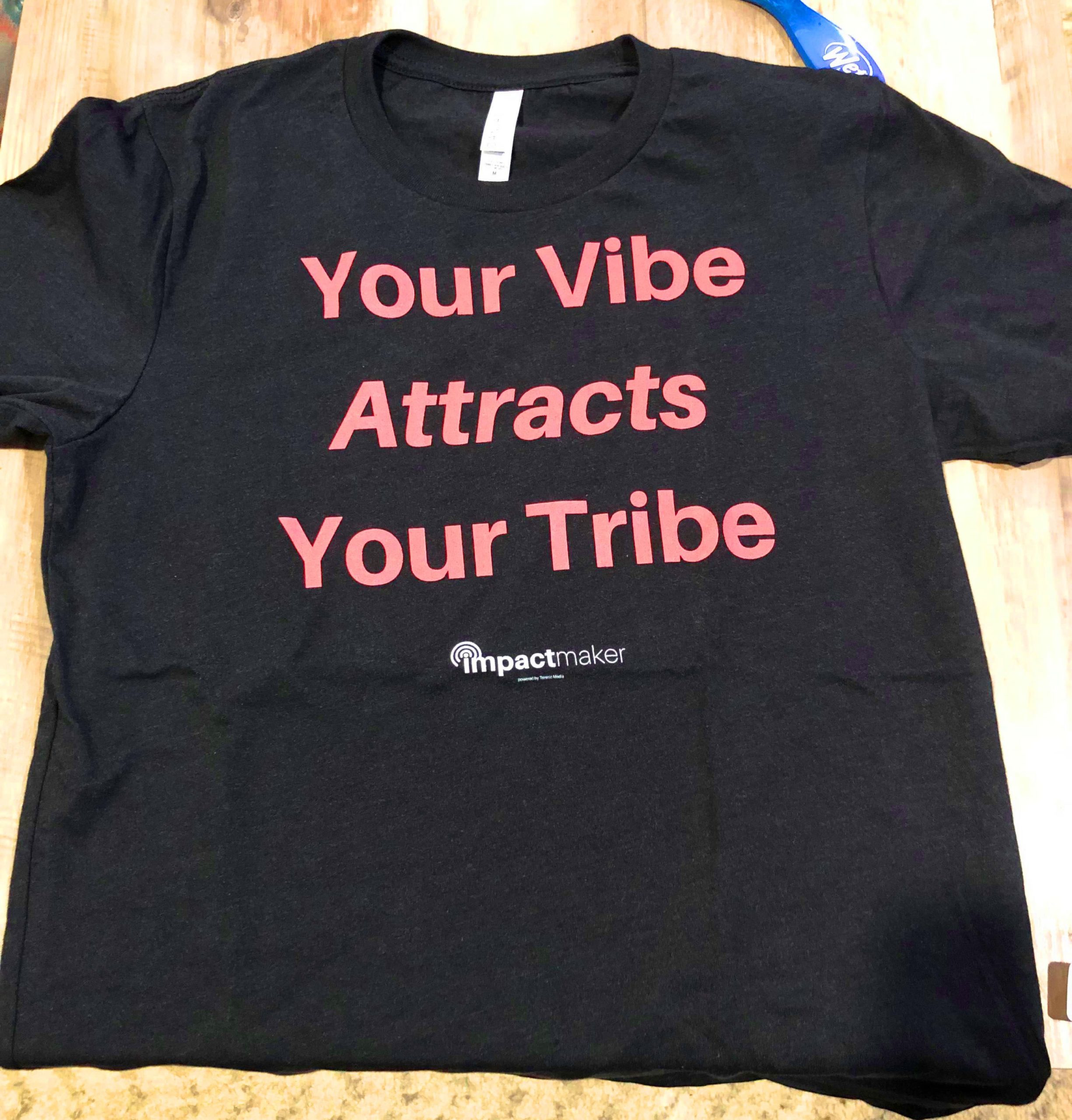 your-vibe-attracts-your-tribe-tshirt-on-table-min